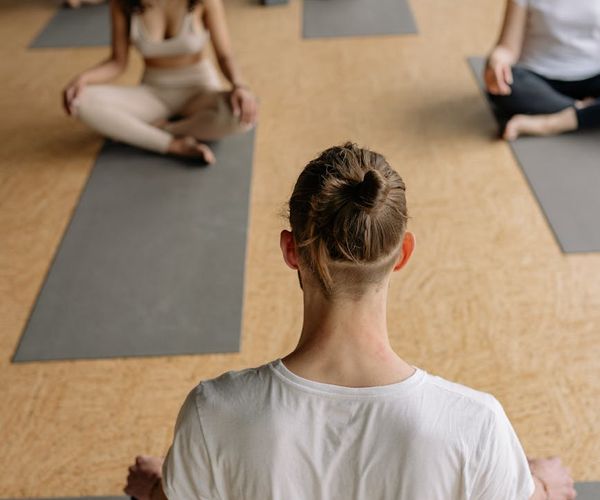 Group of diverse people practicing yoga together in a studio.